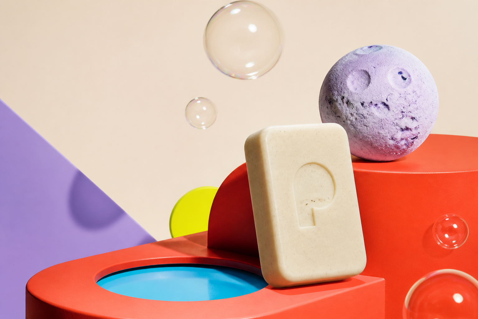POJO soap and lavender bath bomb in a colorful surreal studio set